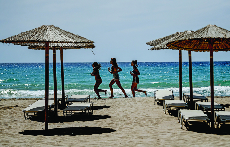 Umbrellas are seen by the sea at Falaserna (Phalasarna) beach on the western coast of Crete island on Saturday. - AFP n