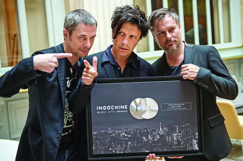 In this file photo French band Indochine members (from left) guitarist Boris Jardel, singer Nicola Sirkis and guitarist Oli de Sat pose in Paris, after being awarded by a double platinium disc.—AFP photosn