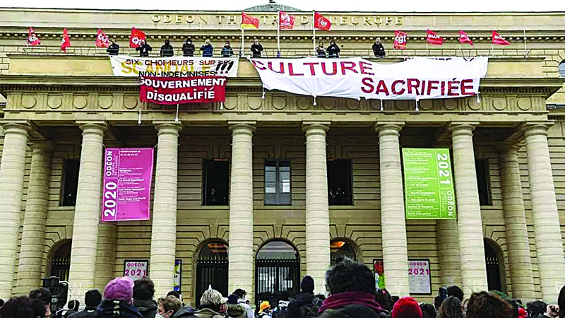 File photo shows demonstrators gather as union members hang banners and flags from the balcony of the Odéon theatre in Paris, to demand the reopening of cultural establishments in France.—AFP n