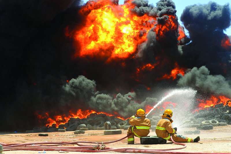 KUWAIT: Firefighters battle a blaze at a tire dump in Salmi on Thursday. 