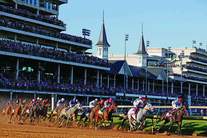 LOUISVILLE: Medina Spirit #8, ridden by jockey John Velazquez, leads the field around the first during the 147th running of the Kentucky Derby at Churchill Downs on Saturday in Louisville, Kentucky. - AFPn