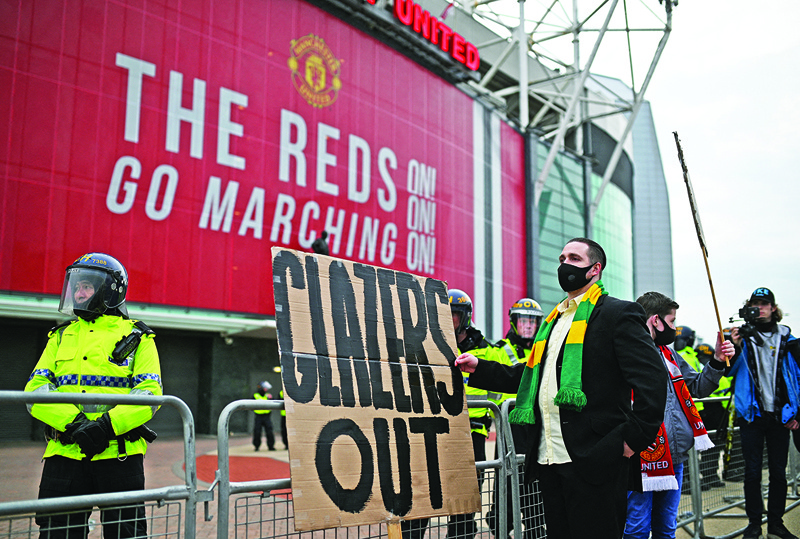MANCHESTER: Demonstrators protest against Manchester United's owners outside Old Trafford stadium in Manchester, north west England, on Thursday, ahead of the English Premier League football match between Manchester United and Liverpool. - AFPn