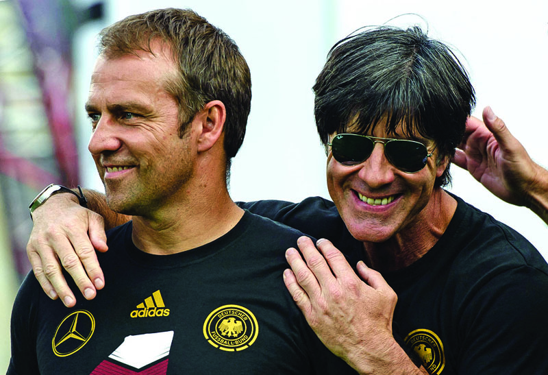 BERLIN: Picture taken on July 15, 2014 shows Germany's head coach Joachim Loew (right) and then Germany's assistant coach Hansi Flick celebrating during a victory parade of Germany's football national team at Berlin's landmark Brandenburg Gate to celebrate their FIFA World Cup title. – AFPnn