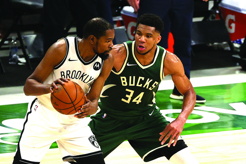 MILWAUKEE: Kevin Durant #7 of the Brooklyn Nets is defended by Giannis Antetokounmpo #34 of the Milwaukee Bucks during the second half of a game at Fiserv Forum on Sunday in Milwaukee, Wisconsin. - AFPn