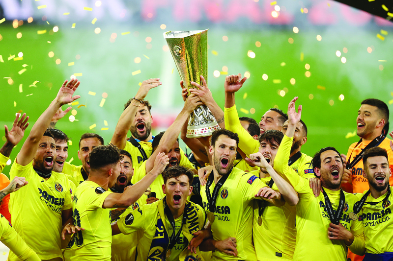 GDANSK: Villarreal's players lift the trophy after winning the UEFA Europa League final football match between Villarreal CF and Manchester United at the Gdansk Stadium in Gdansk on Wednesday. - AFPnn
