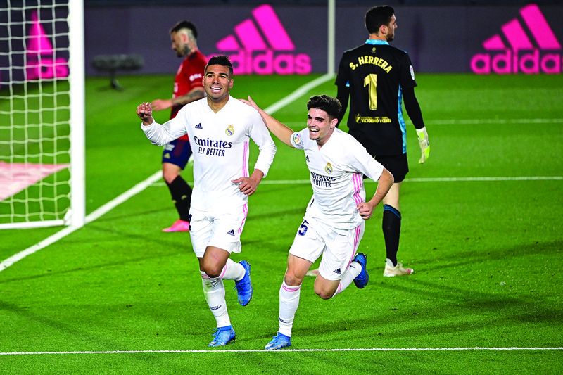 MADRID: Real Madrid's Brazilian midfielder Casemiro (left) celebrates after scoring during the Spanish League football match between Real Madrid and Osasuna at the Alfredo Di Stefano stadium in Valdebebas in the outskirts of Madrid on Saturday. - AFPn