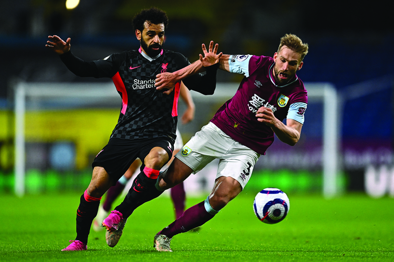 BURNLEY: Liverpool's Egyptian midfielder Mohamed Salah (left) vies with Burnley's English defender Charlie Taylor during an English Premier League match at Turf Moor on Wednesday. – AFP n