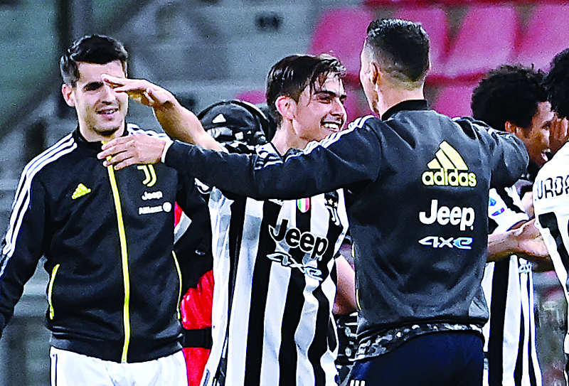 BOLOGNA: (From left) Juventus' Spanish forward Alvaro Morata, Juventus' Argentine forward Paulo Dybala and Juventus' Portuguese forward Cristiano Ronaldo celebrate after Juventus secured its qualification for the Champions League at the end of the Italian Serie A football match Bologna vs Juventus Turin on Sunday at the Renato-Dall'Ara stadium in Bologna. - AFPn