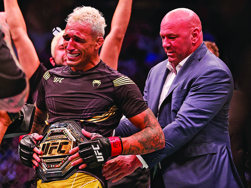 HOUSTON: Dana White places the belt on Charles Oliveira after he defeated Michael Chandler during their Championship Lightweight Bout at the UFC 262 event at Toyota Center on Saturday in Houston, Texas. - AFPn