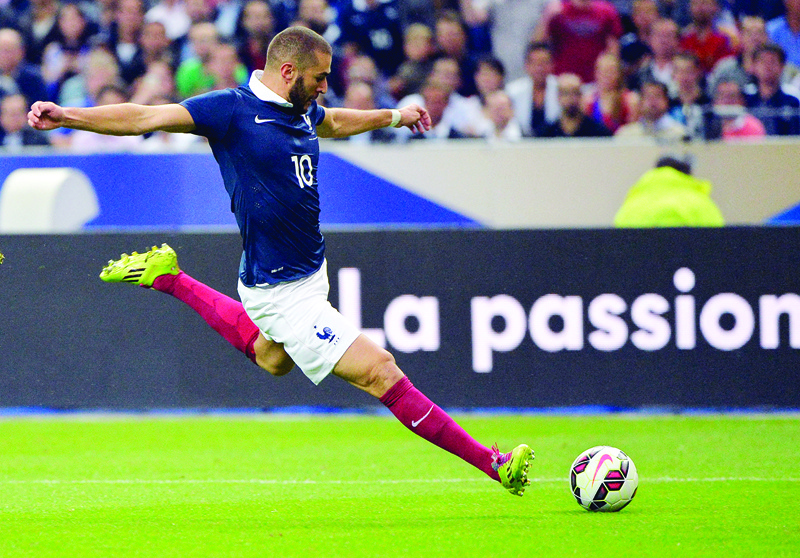 SAINT-DENIS: In this file photo taken on September 4, 2014 French forward Karim Benzema strikes during the friendly football match France vs Spain, at the Stade de France in Saint-Denis, north of Paris. - AFPnn