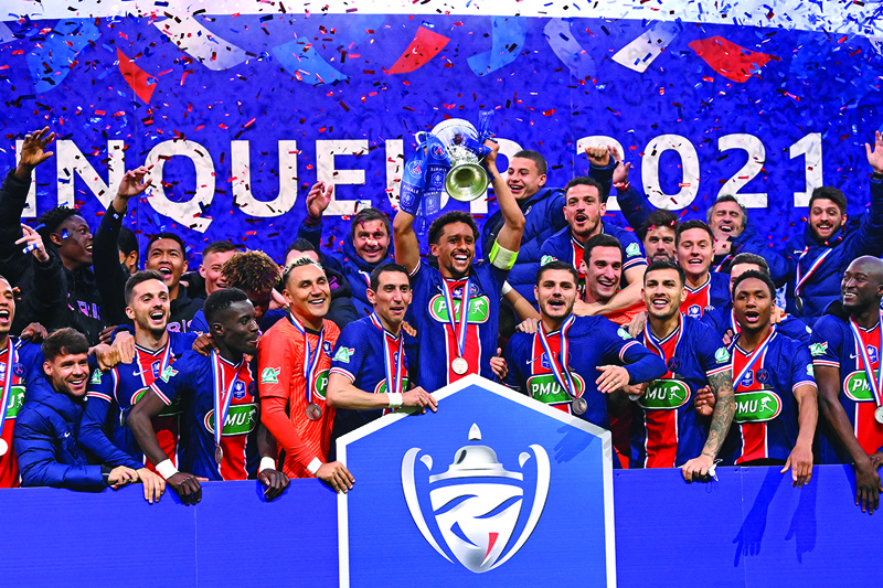 PARIS: Paris Saint-Germain's Brazilian defender Marquinhos celebrates with the trophy after winning the French Cup final against Monaco at the Stade de France stadium in Saint-Denis on Wednesday. – AFP n