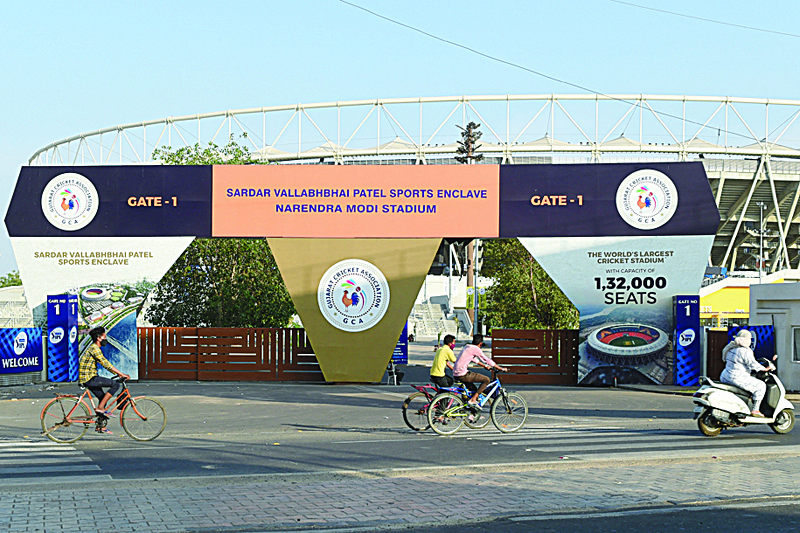 AHMEDABAD: Cyclists cycle past the main entrance of the Narendra Modi Stadium, a venue iwhere cricket matches were taking place during the 2021 Indian Premier League (IPL), in Motera on Tuesday following IPL's decision to suspend the tournament for safety reasons as India battles a massive surge in coronavirus cases. - AFPnn