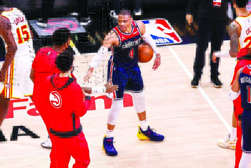 ATLANTA: Russell Westbrook #4 of the Washington Wizards is congratulated by Atlanta Hawks players after breaking the NBA career triple-double record in a game between the Washington Wizards and the Atlanta Hawks at State Farm Arena on Monday in Atlanta, Georgia. - AFPn