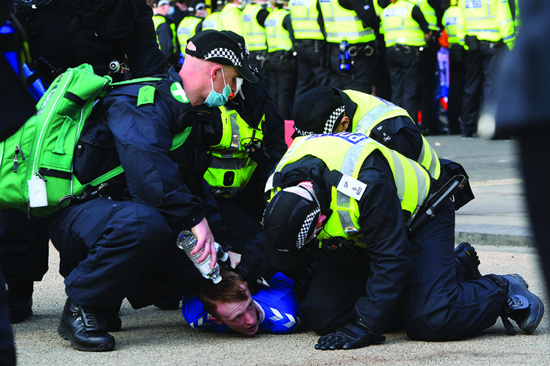 GLASGOW: Police make an arrest as Rangers fans celebrate in George Square in Glasgow on Saturday, after Rangers lift the Scottish Premiership trophy for the first time in 10 years. - AFPn