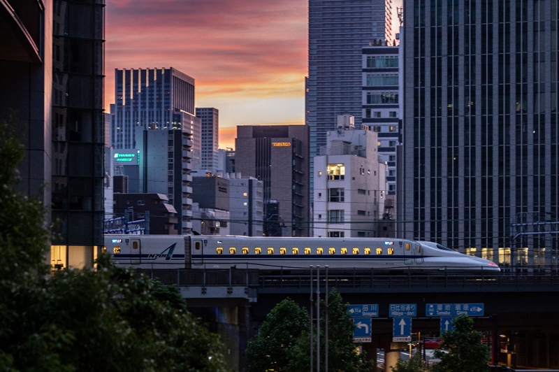 TOKYO: Buildings are seen at dusk as a shinkansen, or high-speed bullet train, passes by in Tokyo yesterday. - AFPn