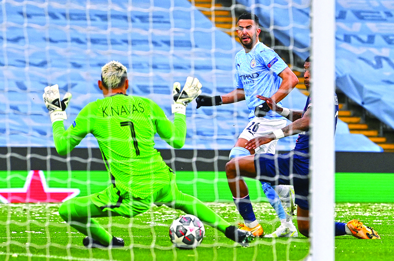 MANCHESTER: Manchester City's Algerian midfielder Riyad Mahrez (center) scores the opening goal during the UEFA Champions League second leg semi-final football match between Manchester City and Paris Saint-Germain (PSG) at the Etihad Stadium in Manchester, north west England, on Tuesday. - AFPn