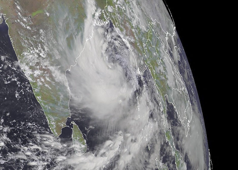 This RAMMB/CIRA handout satellite image shows a cyclone (right) approaching eastern India on Monday at 09:00 UTC. -AFP n