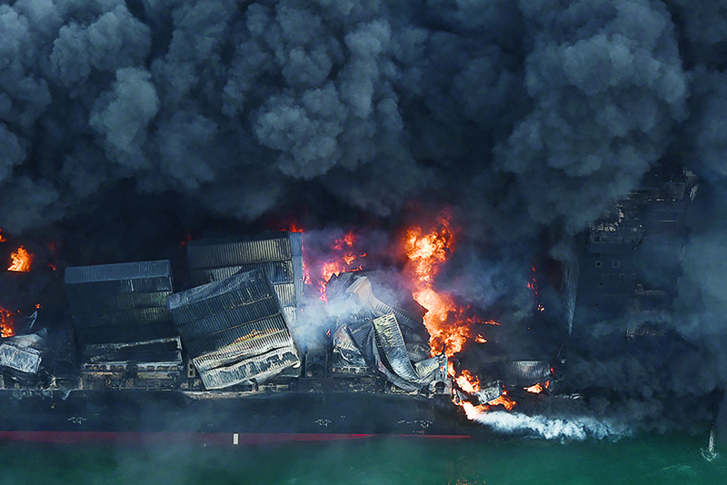 COLOMBO: This handout photograph shows flames and thick smoke billowing from the Singapore-registered container ship MV X-Press Pearl, which has been burning for the seventh consecutive day, in the sea off Sri Lanka's Colombo Harbor. — AFP n
