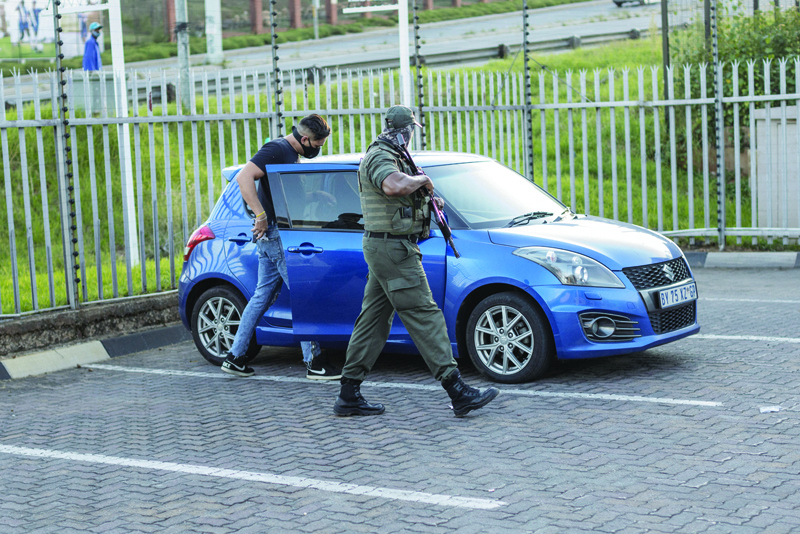 JOHANNESBURG: A security guard of the private security company CORTAC takes position in the parking lot of a shopping mall during a call on his night shift in Johannesburg. S—AFPnnn