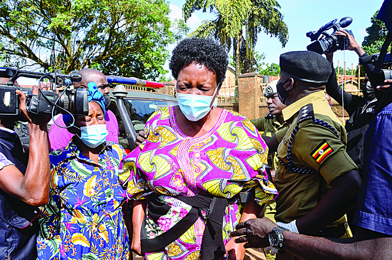 KAMPALA: The wife of Uganda's transport minister General Katumba Wamala (C) arrives at the crime scene where the minister was shot in his car in Kampala, Uganda, yesterday. Uganda's transport minister, who used to lead the armed forces, was shot in an attack which left his daughter and bodyguard dead, a government spokesman said. - AFPnnnn