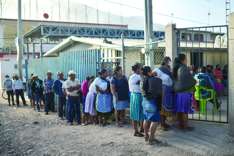GUERRERO: People queue to cast their votes at a polling station in Nahuat community of Atzacoaloya, Guerrero state, Mexico, yesterday. - AFPnnn