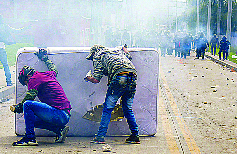 FACATATIVA: Demonstrators take cover behind a mattress during clashes with riot police which erupted during a protest against the government of Colombian President Ivan Duque, in Facatativa, Colombia. - AFPnnn