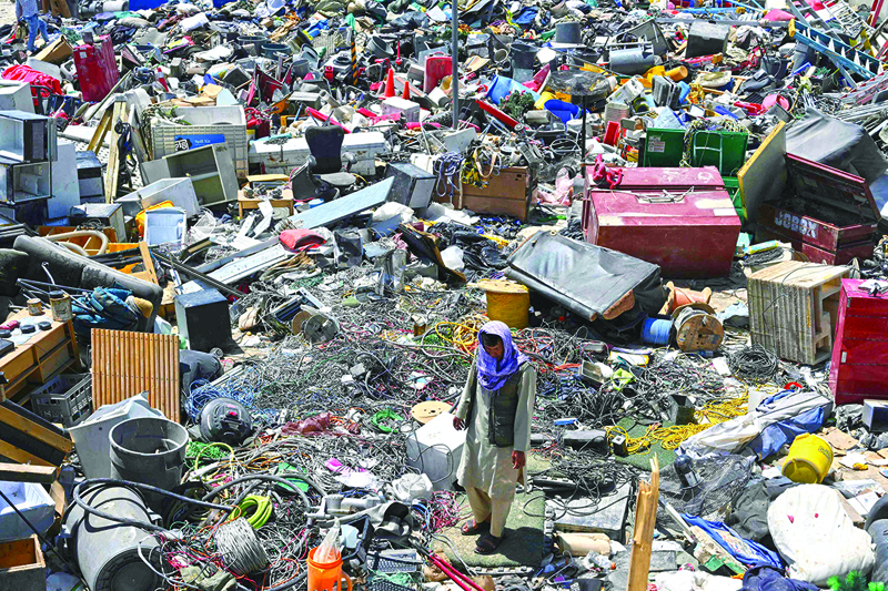 A man selects valuable items at a recycling workshop near the Bagram Air Base on June 17, 2021. – AFPn