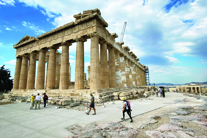 Tourists visit the ancient temple of Parthenon on Acropolis hill in Athens on Friday. - AFPnn