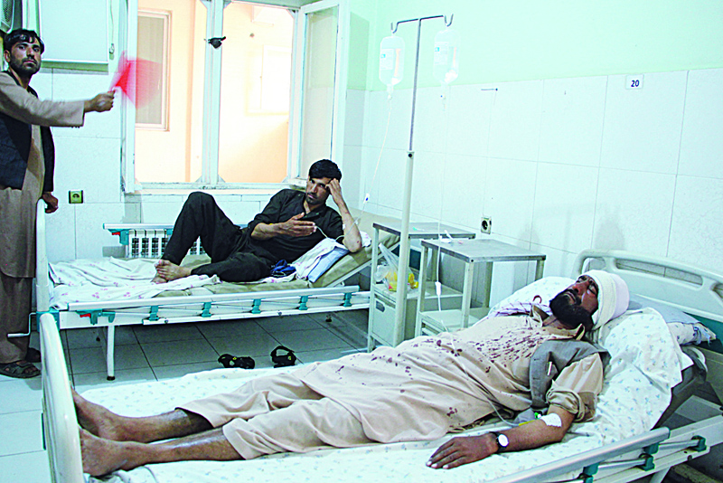 Wounded people receive treatments at a hospital following an attack by masked gunmen which killed 10 people working for the HALO Trust mine-clearing organisation, at Pol-e-Khomri in Baghlan Province yesterday.nAFPn