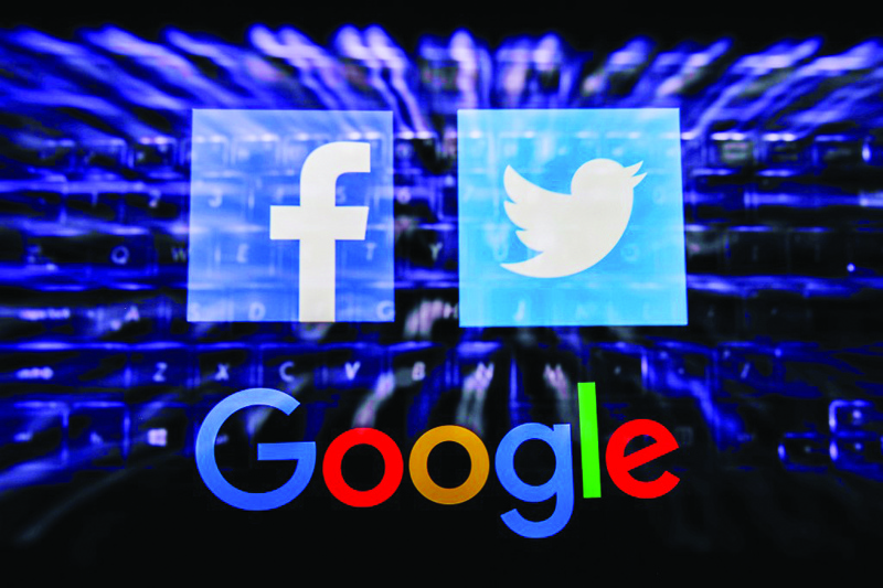 Facebook, Twitter and Google logos displayed on a phone screen and keyboard are seen in this multiple exposure illustration photo taken in Poland on June 14, 2020. European Commission officials said that Facebook, Twitter and Google should provide monthly fake news reports to prevent fake news about coronavirus pandemic. (Photo Illustration by Jakub Porzycki/NurPhoto)