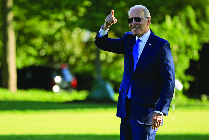 WASHINGTON, DC: US President Joe Biden points to staff members from the South Lawn as he departs the White House Friday in Washington, DC. – AFPn