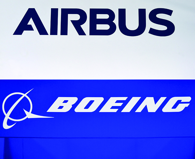 PARIS: File combination photograph created on March 3, 2021, shows the company sign of Airbus in Donauwoerth, southern Germany on July 20, 2020 (TOP) and the Boeing logo in Washington DC on October 22, 2019. United Airlines have announced yesterday, a huge new plane order with Boeing and Airbus in the biggest bet thus far by a major carrier on a travel industry recovery from COVID-19. - AFPnnn