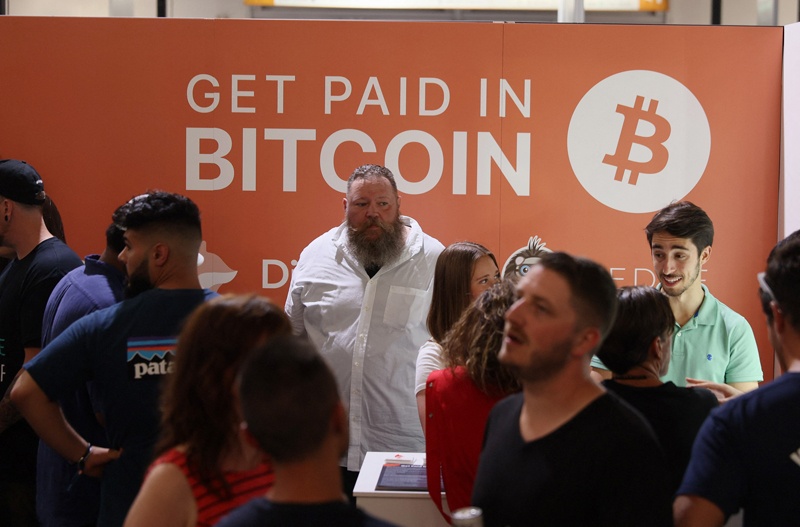 MIAMI, Florida: Dave Pope (center), works in the Digifox booth setup at the Bitcoin 2021 Convention, a crypto-currency conference held at the Mana Convention Center in Wynwood Friday in Miami. – AFPn