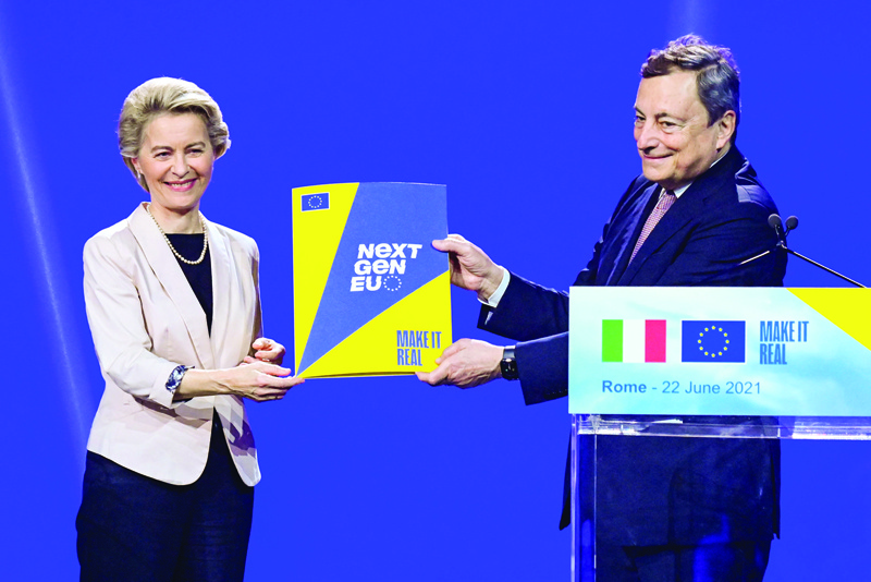 ROME: Italy's Prime Minister, Mario Draghi poses with the Next Generation EU recovery plan, handed to him by European Commission President, Ursula von der Leyen (L) during a joint press conference at Rome's Cinecitta cinema studio. - AFPnn