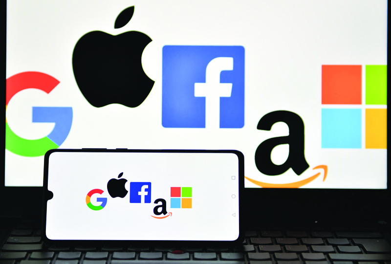 LONDON: File photo taken on December 18, 2020, an illustration picture taken in London shows the logos of Google, Apple, Facebook, Amazon and Microsoft displayed on a mobile phone and a laptop screen. US lawmakers take a first step toward regulating Big Tech yesterday with a vote on a series of bills with potentially massive implications for large online platforms and consumers who use them. --- AFPnnn
