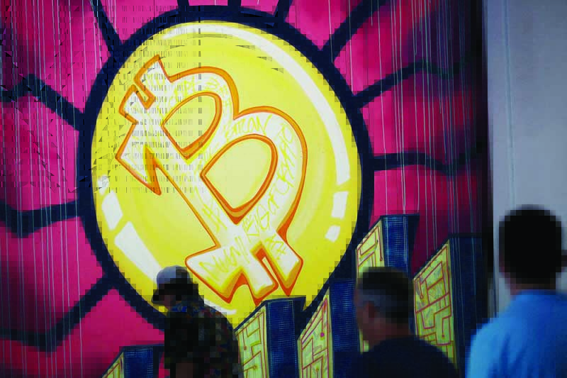 MIAMI: A banner with the logo of bitcoin is seen during the crypto-currency conference Bitcoin 2021 Convention at the Mana Convention Center in Miami, Florida. - AFPn
