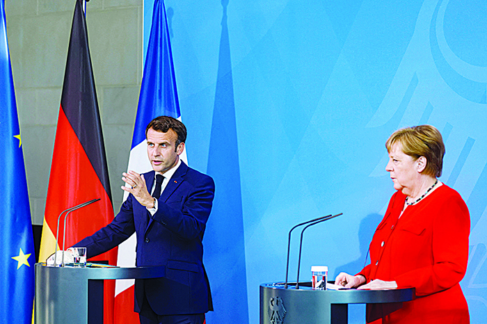 BRUSSELS: German Chancellor Angela Merkel and French President Emmanuel Macron address a press conference ahead of talks at the Chancellery in Berlin. —AFP