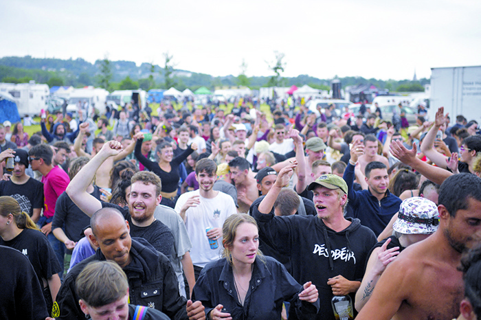 REDON: Participants take part in an illegal rave party in a field in Redon, north-western France, yesterday. Five police officers were injured overnight in western France as they broke up a 1,500-strong illegal rave, authorities said yesterday, —AFP