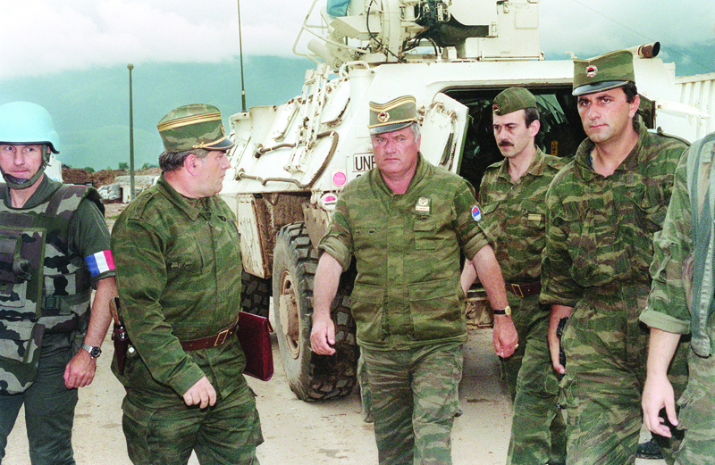 MOUNT IGMAN: File photo taken in Sarajevo on August 10, 1993 shows Commander of Serbian forces in Bosnia General Ratko Mladic (C) arriving at the airport of Sarajevo in order to negociate the withdrawal of his troops from Mount Igman. - AFPn