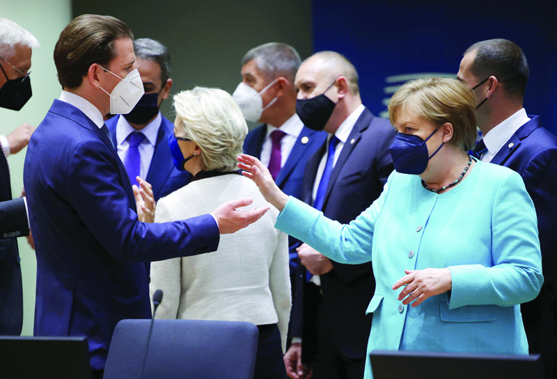 BRUSSESL: Germany's Chancellor Angela Merkel (right), talks to Austrian Chancellor Sebastian Kurz on the first day of a European Union (EU) summit at The European Council Building in Brussels yesterday. - AFPn