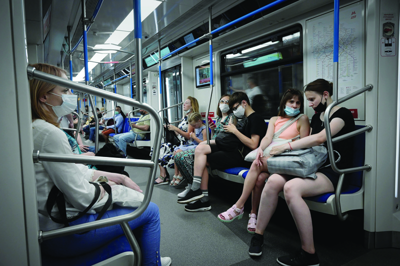 MOSCOW: Passengers sit in the subway, in Moscow yesterday amid the ongoing COVID-19 pandemic. - AFP