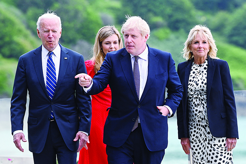 CARBIS BAY: Britain's Prime Minister Boris Johnson (C) and his wife Carrie Johnson (R) walk with US President Joe Biden (L) and US First Lady Jill Biden at Carbis Bay, Cornwall yesterday, ahead of the three-day G7 summit being held from 11-13 June. - AFPnnn