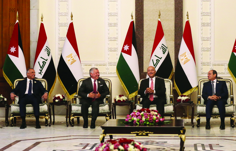 BAGHDAD: Iraqi President Barham Saleh (second right) and Prime Minister Mustafa Al-Kazemi (left) receive Egypt's President Abdel Fattah Al-Sisi (right), and Jordan's King Abdullah II (second left) in Baghdad yesterday.-AFPn