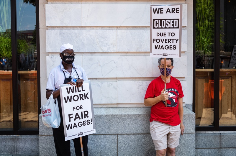 WASHINGTON: Activists take part in a protest outside of the Old Ebbitt Grill to call for a full minimum wage with tips for restaurant workers on May 26, 2021. – AFP n