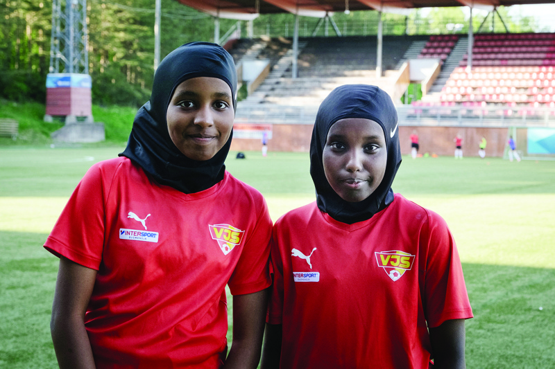 VANTAA, Finland: Kamila Nuh (left) and Nasro Bahnaan Hulbade, both 13 years old, pose for photos at the beginning of a football training session at the MUP Stadium on June 1, 2021. - AFP n