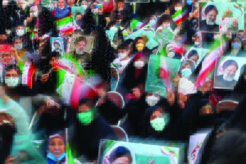TEHRAN: Supporters of Iranian presidential candidate Ebrahim Raisi attend an election campaign rally on Monday. - AFP n