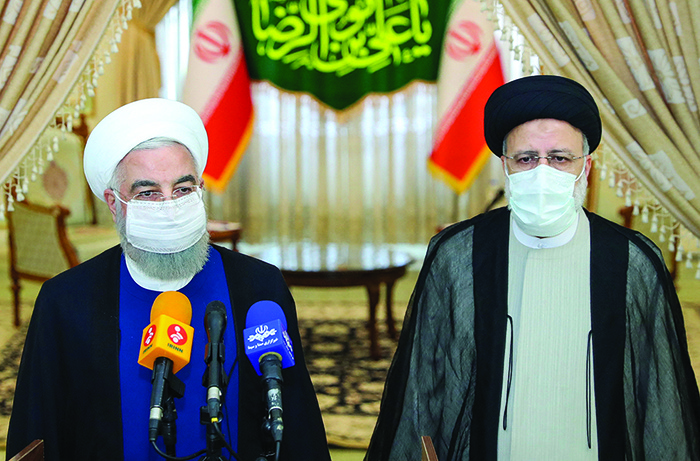 TEHRAN: Outgoing President Hassan Rouhani (left) takes in part in a press conference with President-elect Ebrahim Raisi during his visit to congratulate the ultraconservative cleric on winning the presidential election yesterday. — AFP