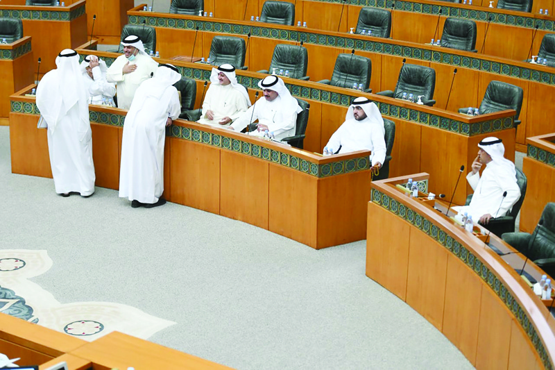 KUWAIT: Opposition MPs occupy ministers' seats at the National Assembly yesterday, which led the government to boycott the session. - Photo by Yasser Al-Zayyatn