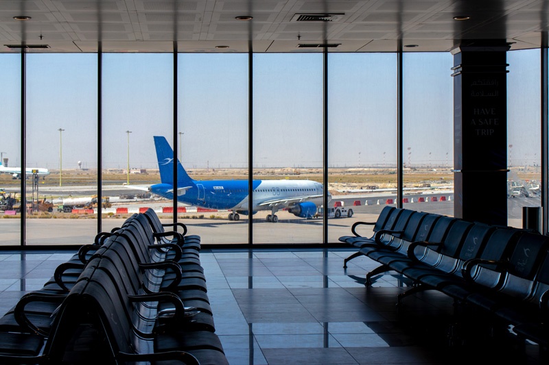 Kuwait international airport, Kuwait - Oct 3 2019: departures lounge, gates area with view of a  Kuwait Airways Boeing 777-369(ER) 9K-ALE.