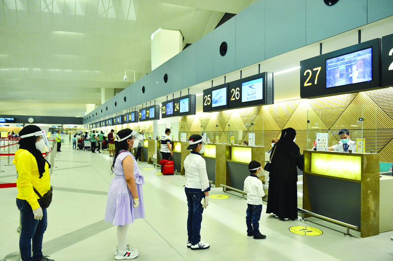 KUWAIT: Passengers check in yesterday as Kuwait Airways resumed commercial flights to London. - KUNA  n